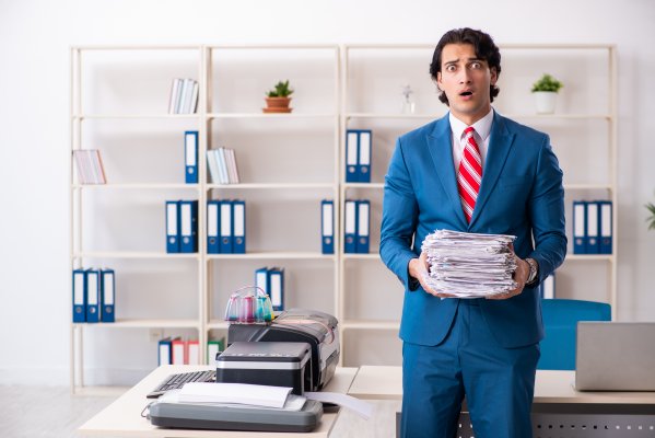 Man in suit not happy with all the faxes he needs to send